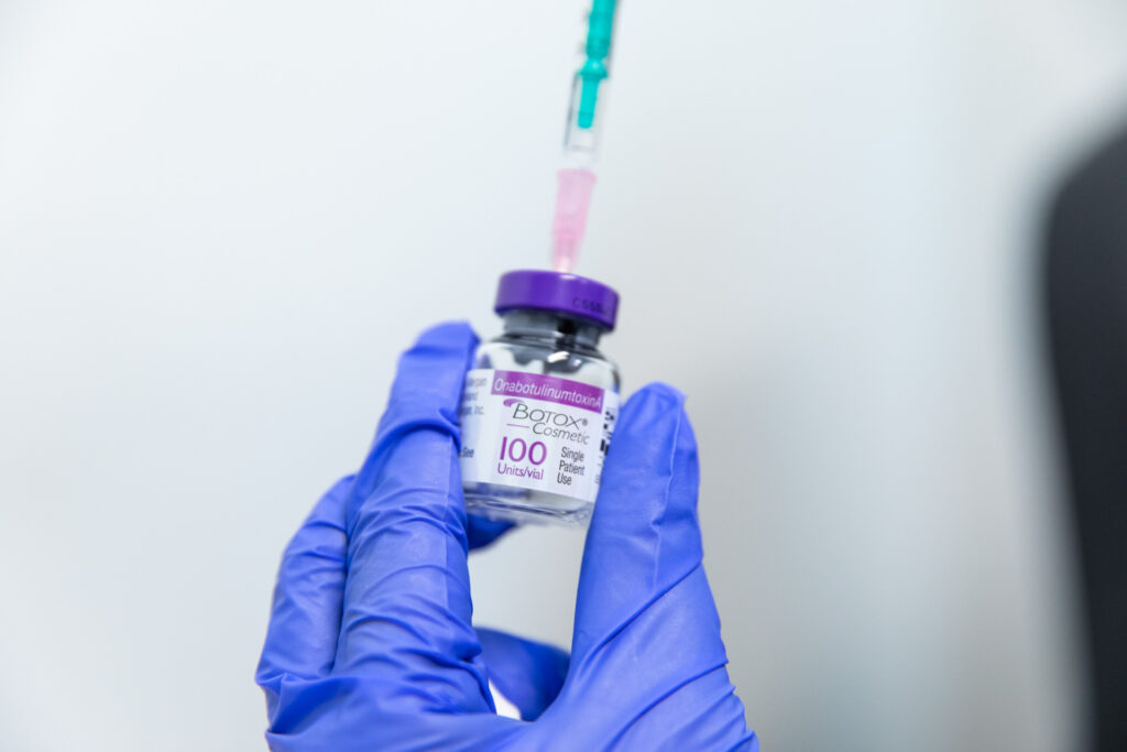The gloved hand of a specialist drawing a vial of Botox near Mountain Lakes, NJ.