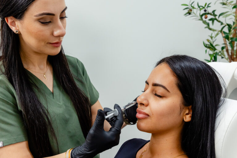 Nurse stands over patient to inject Botox