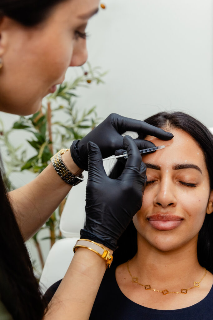 Nurse injects Botox into patient's forehead