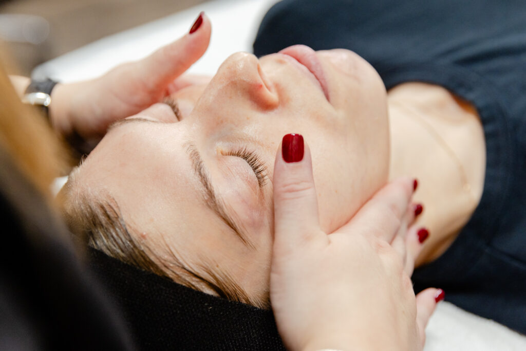 Image of female patient at Exhibit Medical Aesthetics receiving a facial before beginning hormone replacement therapy in Denville.