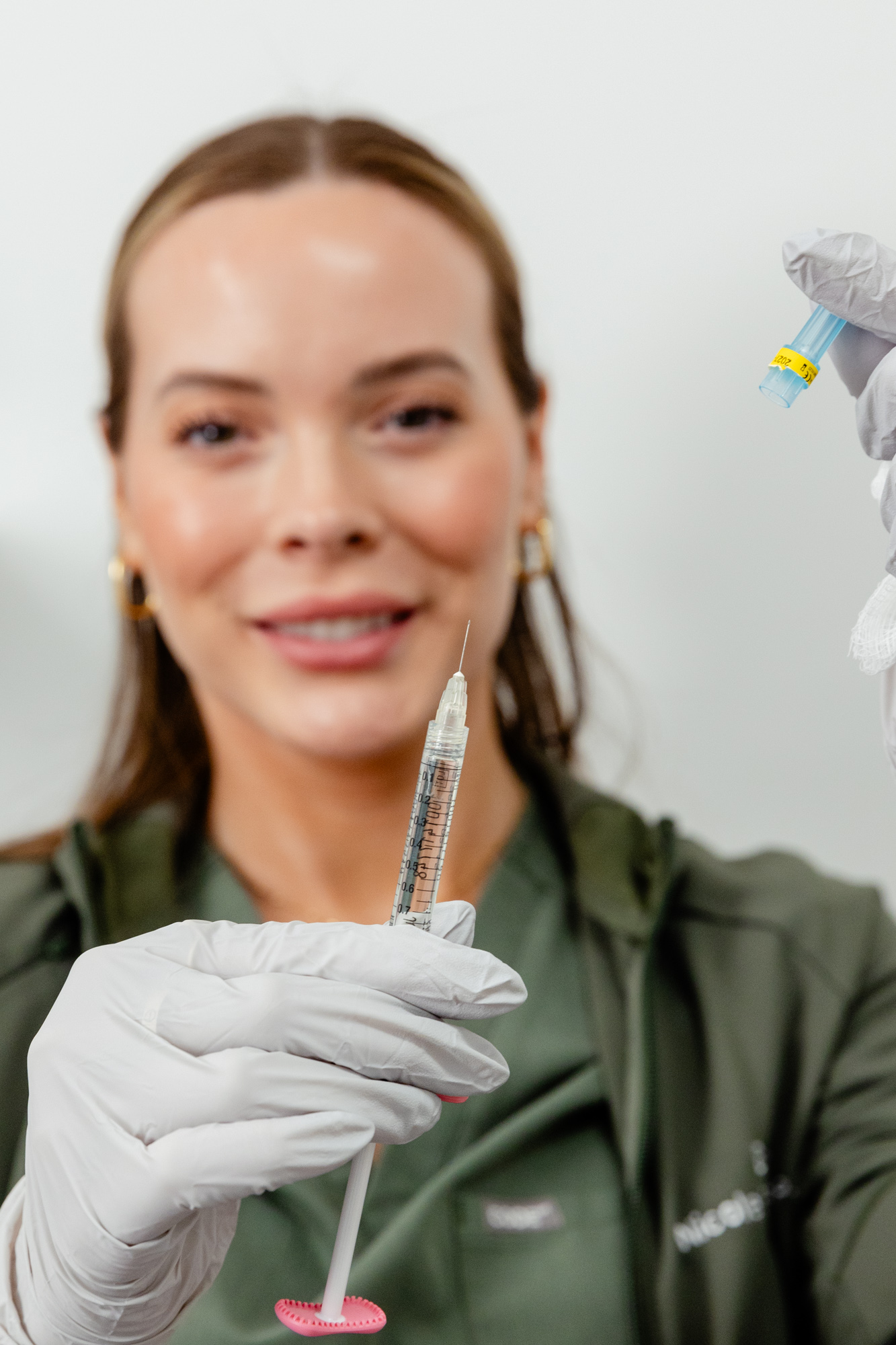 Nurse in gloves holding needle