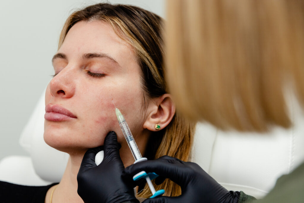 Photo of woman receiving skin booster injection in face