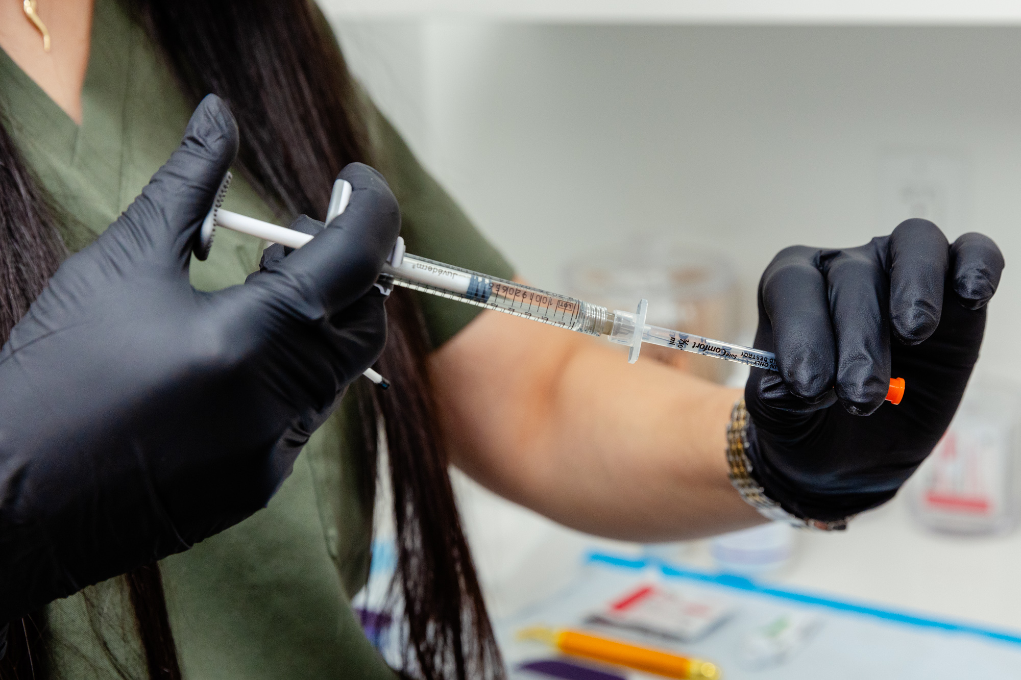Person in gloves holding needle