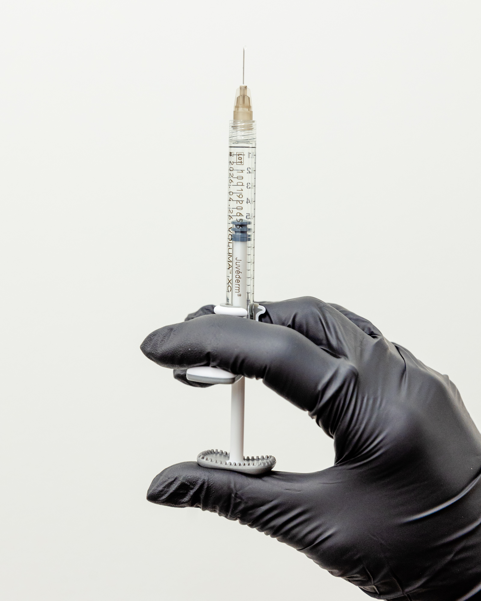 gloved hand holding needle