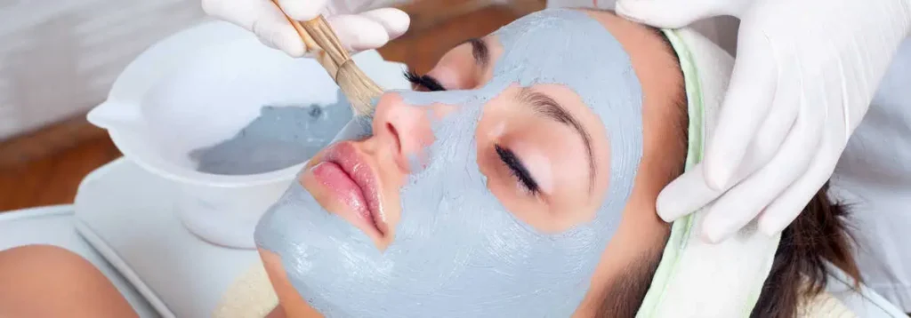 Nurse smoothing facial on patient