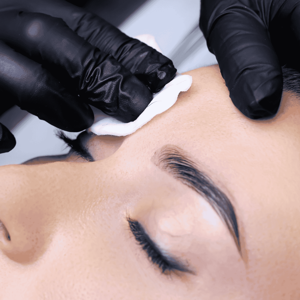 woman getting eyebrow cleansed for lamination service