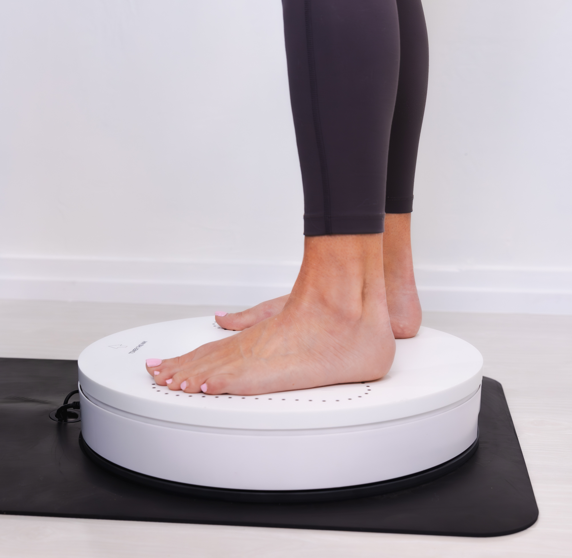 Woman standing on Styku Body Composition device