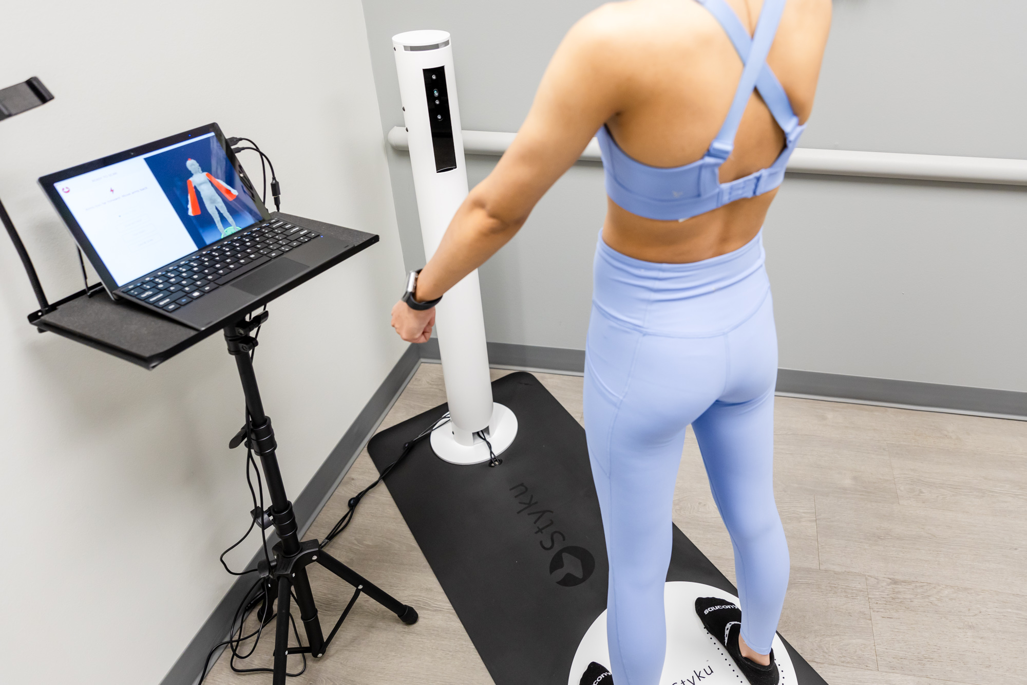 Woman standing firm on the Styku Body Scanner
