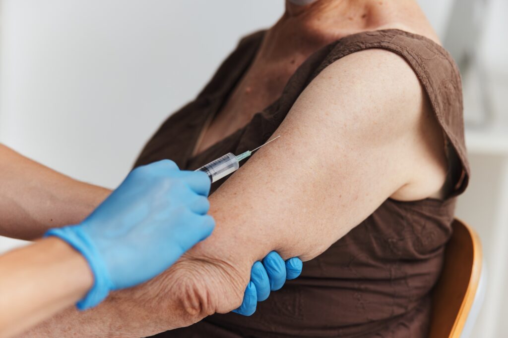doctor giving a shot in the arm vaccination coronavirus. High quality photo