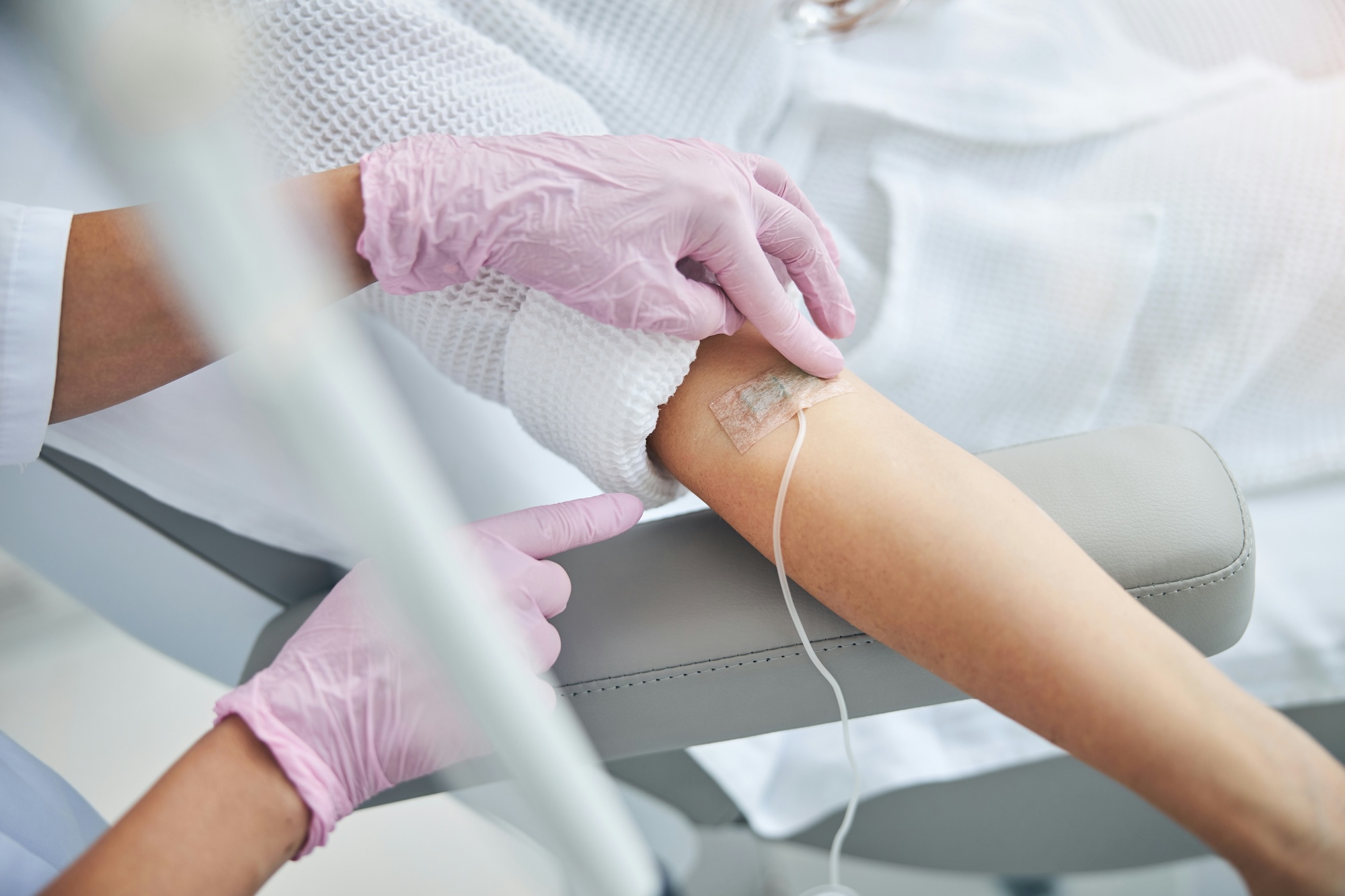 Image of a patient at Exhibit Medical Aesthetics having an IV inserted into their arm so they can receive IV therapy near Mountain Lakes, NJ.