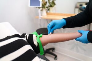 A patient raises her arm as a provider performs PRP injections in Morris County, NJ.