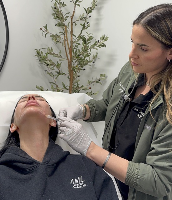 Woman receiving chin filler injection on her jawline