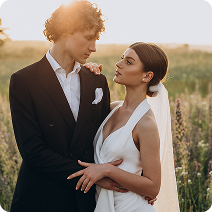 bride and groom admiring each other in a field